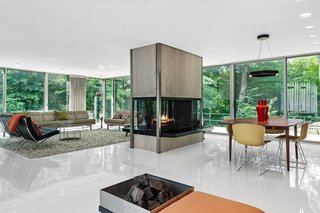 The four-sided fireplace composed of travertine and steel is a focal point for the living and dining areas.