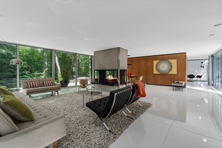 In the main living areas, the concrete slab floor was scored and given a coat of white resin.