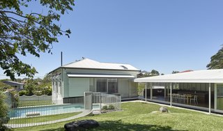 The garden pavilion sits adjacent to the original house and overlooks the reworked garden and new pool. The pool is surrounded by a metal screen element that's also repeated elsewhere in the project.