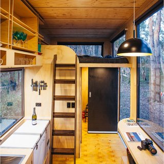 The upper loft has another mattress, so the tiny home can comfortably sleep up to four. Linens are included in the rental.