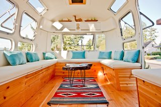Wilson fixed a rotten sub floor and pulled out wet insulation to revamp the interior into a rental space. Clients can adapt the decor of the lounge to their needs, or choose one of the curated looks available. This front area can seat fifteen people.