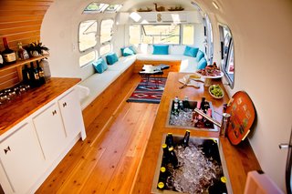 The interior includes a blue tooth/CD/iPod-receiver sound system, AC, and mini fridge.