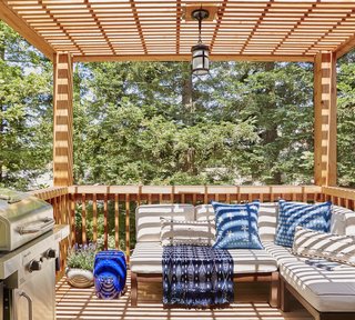 The upper level of the deck now provides a cozy hangout spot right off the kitchen. The roof casts beautiful dappled shade.