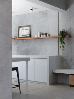 The entrance to the galley kitchen, with the tile repeated below the built-in bench.