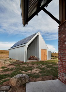 The shed was custom-designed with a shed kit company, and is clad in heritage-grade corrugated galvanized iron. It houses land-care equipment, as well as the PV panels and battery.