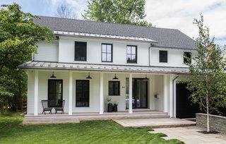 The four-bedroom, three-and-a-half-bath Passive House presents a welcoming and streamlined front porch to the street. "Fortunately, the positioning of the house allowed us to provide more traditionally proportioned windows at the front on the north side, with larger, lean metal units that open views to the backyard," explain the architects.