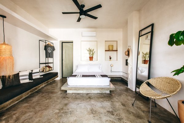 A floating concrete bench and inset wall niches adorn a 240-square-foot room.