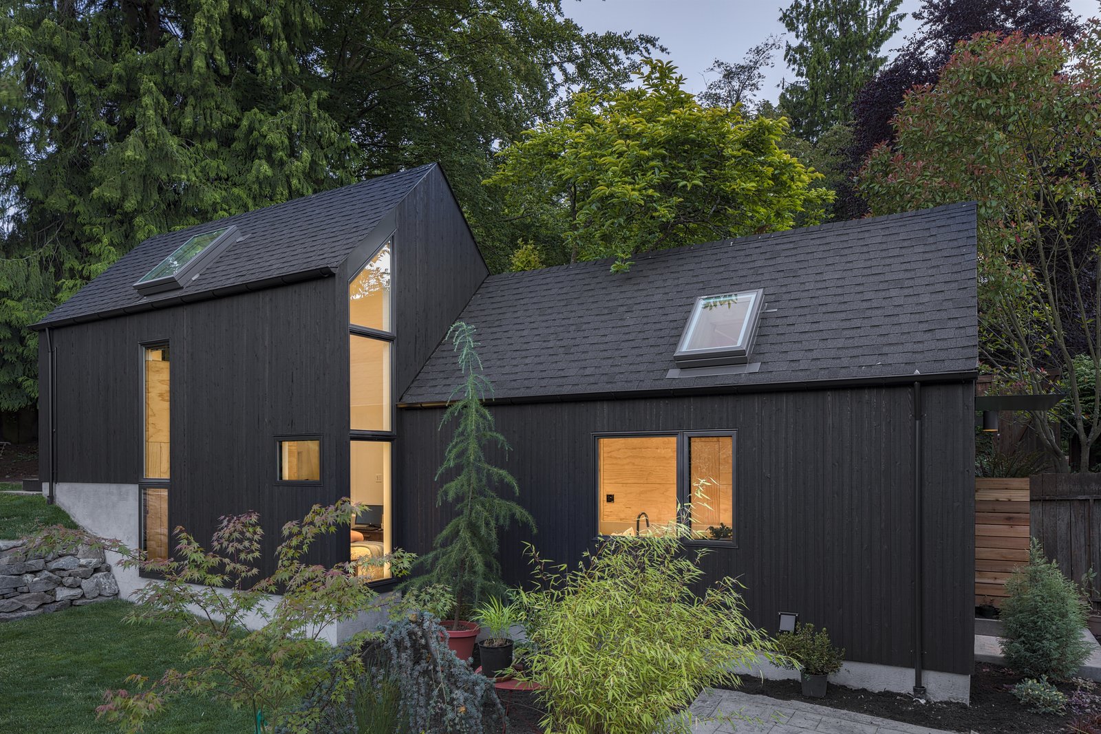 The architects worked with the natural, six-foot slope of the site and built the Granny Pad into the hill to gain the needed interior height. The volume on the right is the original garage footprint, which now houses a kitchen and sitting room. The added volume on the left hosts the bedroom, as well as a bathroom beneath the loft space.