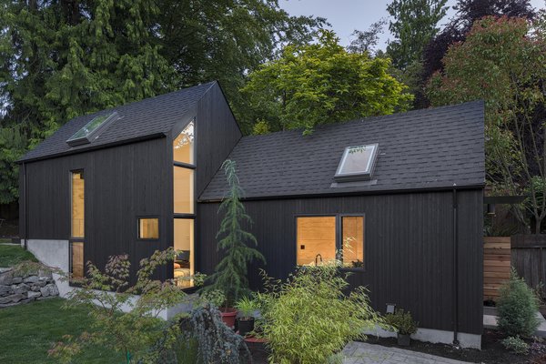 The architects worked with the natural, six-foot slope of the site and built the Granny Pad into the hill to gain the needed interior height. The volume on the right is the original garage footprint, which now houses a kitchen and sitting room. The added volume on the left hosts the bedroom, as well as a bathroom beneath the loft space.
