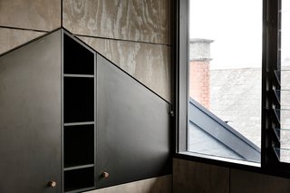 In an upstairs bedroom, striking triangular cabinetry is built into the Victorian home's attic.