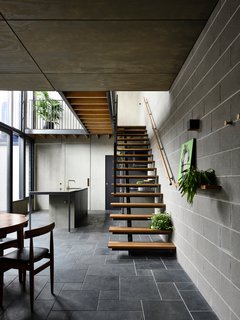 At the rear of the property, the team added a two-story extension, which included this open-concept kitchen and dining area, as well as bathrooms, bedrooms, and a lounge area.