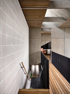 A view of the catwalk leading to the bedroom. Blackbutt ceiling slats relate to the exterior pergola.