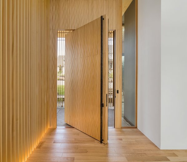 The ten-by-six-foot solid wood door has a traditional "waving wood" pattern to the surface.