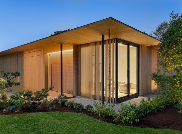 The entry is tucked behind a louvered screen, creating a winding path to the front door. The screen, composed of Alaskan Yellow Cedar, shields views from the sidewalk while still allowing interior occupants to see out, and evokes "a sense of elegance, mystery, and warmth," says the firm.