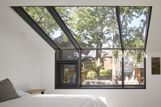 In an upstairs bedroom, a generous skylight from Big Foot Windows and Doors expands the sense of space and increases the natural light.