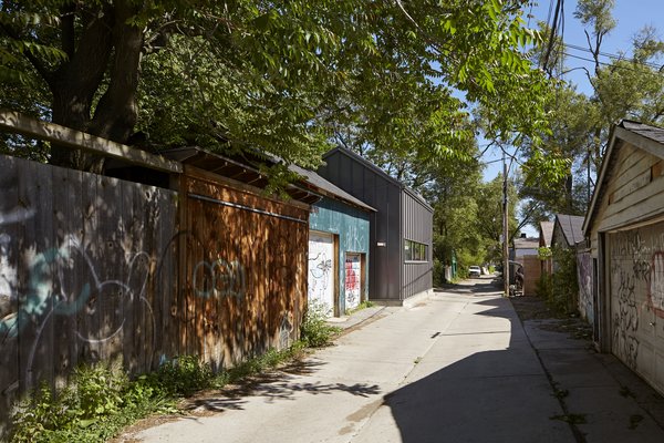 The College Laneway House occupies a small footprint, just 1450-square-feet, where a dilapidated fishing lodge once stood. Its pitched roof blends in with adjacent buildings.