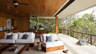 Retractable walls allow the interior to fluidly merge with its natural surroundings. Per the architects: "While trying to always maintain the relationship between built and wild, the indoors opens completely to allow the breeze and the red sunset light to inundate the space."