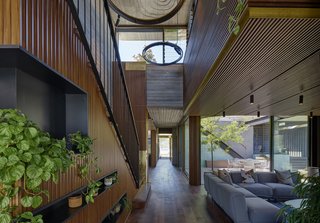 The master bedroom suite sits upstairs and accesses the roof terrace, while the remaining living spaces and bedrooms lie on the main level. There is also a basement. The wall cladding and cabinetry throughout is fashioned in engineered timber from ABODO's Elements range. The engineered wood floors are by Mafi.