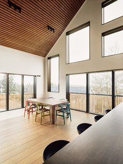 The clients wanted to be able to easily seat 20 people for dinner. To do so, the design team paired Hans J. Wegner Wishbone Chairs in a rainbow of colors with a Skovby #23 dining table, which expands the seating from six to 20 with simple extension leaves.