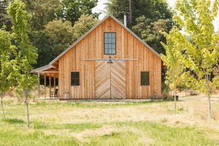 The 1,800-square-foot barn and workshop was designed by architect friend Yianni Doulis. The exterior employs untreated cedar in a reverse board-and-batten style.