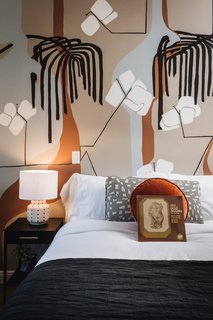 Music is considered the "fabric of the space." Thus the hotel leaves a vinyl compilation for guests to keep on turned-down beds. The vinyl is a collaboration between Aquarium Drunkard and Vinyl Me, Please, and the tracks will change every season. The wall mural here was painted by Kristi Head.
