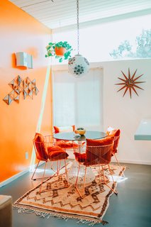 The dining area features Captain chairs and a Bistro table from Bend Goods.