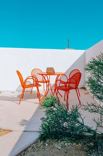 Outside, a punchy dining set spray-painted by Nagel livens up the patio.