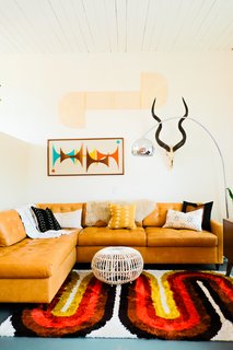 On the other side of the living room, Nagel combined a leather Joybird sectional sofa with an AllModern rug.