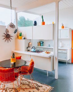 The original kitchen, complete with Krisel-designed pegboard cabinetry, remains in place.