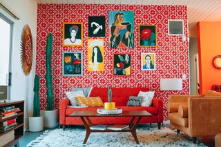 For an eye-catching display, Nagel installed paintings inherited by her grandmother against an accent wall covered in Hygge & West wallpaper. The orange and red pattern is called Arcade, and it was designed by Heath Ceramics.
