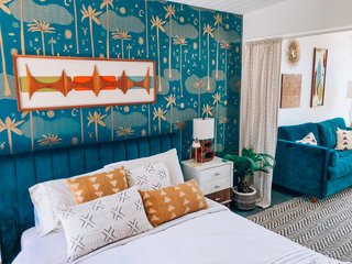 The home once held three bedrooms, but previous owners removed the wall that separated two of them. The adjacent space now hosts a Joybird couch with a pull-out bed, and a workspace, and it can be separated by a curtain for privacy.