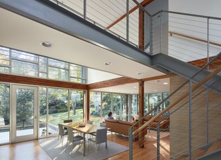 The view from the entry now encompasses open and airy living spaces that connect to the garden via floor-to-ceiling glass. 