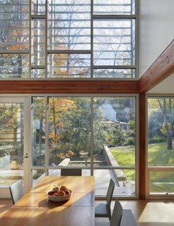 The double-height glass is layered over with a brise-soleil at the upper floor which screens sun, adds visual interest to the facade, and creates lovely interior shadows.