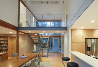 A steel bridge connects the upper level master suite (to the left) with the existing bedrooms to the right.