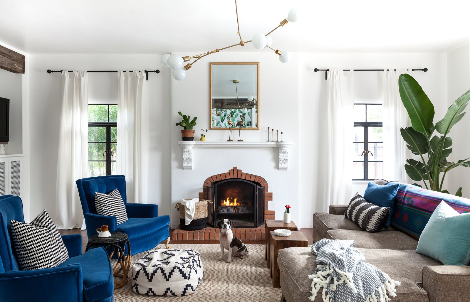The original fireplace was cleaned up and repaired. "Also, the room previously had just a small passageway to the kitchen and no real place to put a television. We’re not big TV watchers, so we wanted to keep the mantle TV-free, so that it was not a focal point of the room," says Valencia. "We opened up the passage to the kitchen to give the home a modern layout and added a built-in TV/media cabinet (on the left wall)."