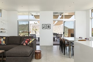 This Modern Homestead With a Vintage Trailer Offers Adventure in California's High Desert - Photo 5 of 10 - The living room of the main house has direct connections to the outdoors and the patio.