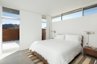 This Modern Homestead With a Vintage Trailer Offers Adventure in California's High Desert - Photo 6 of 10 - The master bedroom looks out at desert peaks.