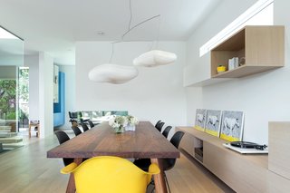 The dining area features a custom table and millwork by Christian Woo.