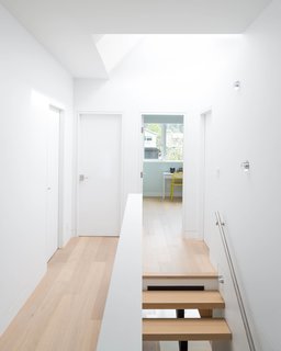 A skylight offers an additional source of daylight from above, allowing light to pass down to all three floors below. 