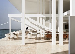 An Exquisite Beach Resort on Baja California Sur Lies Where the Water Meets the Horizon - Photo 1 of 11 - With white travertine floors and muted, modern furnishings by Poliform, this restaurant at the resort is all about the view of the ocean and the sensorial connectivity to it. 