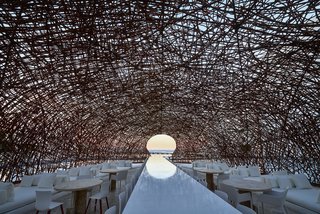 An Exquisite Beach Resort on Baja California Sur Lies Where the Water Meets the Horizon - Photo 4 of 11 - The intertwining canopy protects the lounge seating and dining areas by Poliform, while the singular opening focuses the view out to the horizon. 