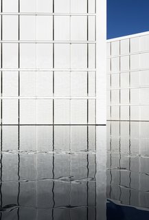 An Exquisite Beach Resort on Baja California Sur Lies Where the Water Meets the Horizon - Photo 6 of 11 - The white concrete panels appear to float on the reflecting pool.