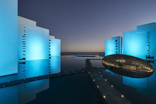 An Exquisite Beach Resort on Baja California Sur Lies Where the Water Meets the Horizon - Photo 10 of 11 - At night, the whole exterior is lit in shades of blue and purple. 