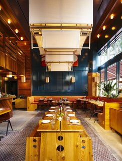 A 1920s Office Building Is Revamped as a Craftsman-Inspired Hotel in Los Angeles - Photo 4 of 10 - A custom lighting element made of fabric and wood floats above the wood dining table as a glowing sculptural piece.