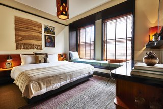 A 1920s Office Building Is Revamped as a Craftsman-Inspired Hotel in Los Angeles - Photo 7 of 10 - The guest rooms combine artwork, textiles, and rich wood tones to provide a luxurious, cozy retreat.