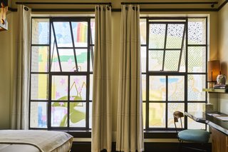 A 1920s Office Building Is Revamped as a Craftsman-Inspired Hotel in Los Angeles - Photo 8 of 10 - A desk looks out at a colorful mural, a reminder of L.A.'s dynamic surroundings.