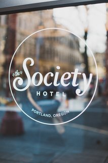 Window graphics provide unobtrusive and elegant signage on the exterior glazing of the historic facade.