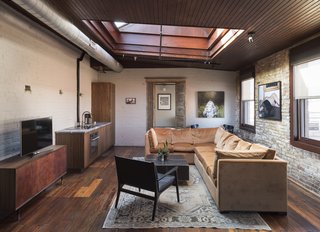 History and Modernity Meet in This Industrial Hotel and Restaurant in Philadelphia - Photo 6 of 11 - In Room 4 on the third floor, a large A-frame skylight allows light to flood into the interior while windows provide views to the neighborhood below. 
