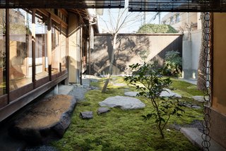 A Minimalist Townhouse Provides Serene Accommodations in Historic Kyoto - Photo 2 of 12 - A lounge space looks onto a calming moss garden and provides the perfect zen setting to relax with a cup of tea.