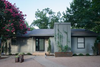 Bringing Light Into a Modest 1940s Bungalow in Austin - Photo 2 of 10 - The front elevation of the home remains modest in appearance with a simple vertical addition, maintaining the typical Austin bungalow aesthetic.